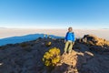 Tourist watching sunrise at Uyuni Salt Flat, travel destination in Bolivia. Wide angle shot from the summit of the Incahuasi Islan