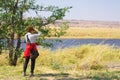 Tourist watching wildlife by binocular on Chobe River, Namibia Botswana border, Africa. Chobe National Park, famous wildlilfe