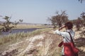 Tourist watching wildlife by binocular on Chobe River, Namibia Botswana border, Africa. Chobe National Park, famous wildlilfe rese Royalty Free Stock Photo