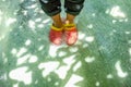 Tourist wear red shoes stang on the clear water in erawan waterfall national park