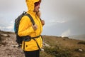 Woman hiking at mountains in extreme weather. Royalty Free Stock Photo