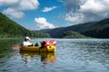 Tourist in white shirt on yellow packraft