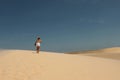 The tourist, the wind and the sand