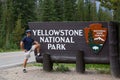 Tourist wit Yellowstone National Park Sign