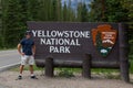 Tourist wit Yellowstone National Park Sign