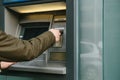 The tourist withdraws money from the ATM for further travel. Grabs a card from the ATM. Finance, credit card, withdrawal