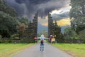 Tourist woman with backpack and hat on vacation walking through the Hindu temple in Bali Indonesia, Handara gate Royalty Free Stock Photo