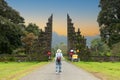 Tourist woman with backpack and hat on vacation walking through the Hindu temple in Bali Indonesia, Handara gate Royalty Free Stock Photo