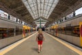 A tourist woman with a backpack on her back, walks along a platform of the Sao Bento train station, in the city of Porto, Portugal Royalty Free Stock Photo