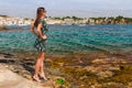 Tourist woman in Cadaques, Catalonia, Spain near of Barcelona. Scenic old town with nice beach and clear blue water in bay. Famous