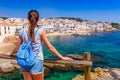 Tourist woman in Calella de Palafrugell, Catalonia, Spain near of Barcelona. Scenic fisherman village with nice sand beach and