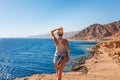 Tourist woman in Dahab near Blue Hole at the Red Sea coast. Famous travel destionation in desert. Sharm el Sheik, Dahab, Sinai
