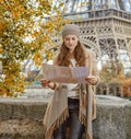 Tourist woman on embankment near Eiffel tower looking at map Royalty Free Stock Photo