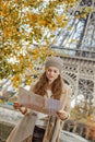 Tourist woman on embankment near Eiffel tower looking at map Royalty Free Stock Photo