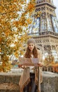 Tourist woman on embankment near Eiffel tower looking at map Royalty Free Stock Photo