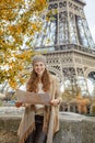 Tourist woman on embankment near Eiffel tower in Paris with map Royalty Free Stock Photo