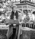 Tourist woman on embankment near Eiffel tower in Paris with map Royalty Free Stock Photo