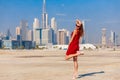 Tourist woman enjoying view of Dubai with palms and skyscrapers from the desert. Sunny summer day in Dubai desert. Dubai is famous Royalty Free Stock Photo