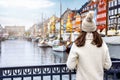 A tourist woman enjoys the view to the beautiful Nyhavn area in Copenhagen Royalty Free Stock Photo