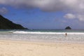 Tourist woman enters sea at Mawun beach, Lombok