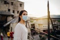 Tourist woman with face mask travelling to European cities during coronavirus pandemic outbreak.Travel to Europe amid COVID-19. Royalty Free Stock Photo