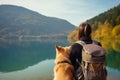 Tourist woman with her dog admiring scenic lake view. Generate ai Royalty Free Stock Photo