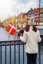 A tourist woman enjoys the view of the beautiful Nyhavn area in Copenhagen Royalty Free Stock Photo