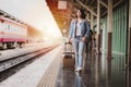 Tourist woman with luggage at the train station