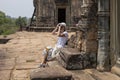 Tourist woman making pictures in Pre Rup temple, Angkor Wat complex, Cambodia. Tourist photographer in Angkor Wat. Royalty Free Stock Photo