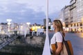 A tourist woman in the marina of a city