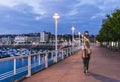 A tourist woman in the marina of a city