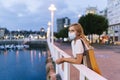 A tourist woman in the marina of a city