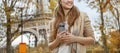 Tourist woman near Eiffel tower with cellphone looking aside Royalty Free Stock Photo