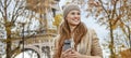 Tourist woman near Eiffel tower with cellphone looking aside Royalty Free Stock Photo