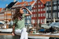 Tourist woman at the Nyhavn harbor pier Copenhagen, Denmark. Royalty Free Stock Photo