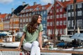 Tourist woman at the Nyhavn harbor pier Copenhagen, Denmark. Royalty Free Stock Photo