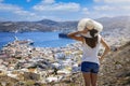 A tourist woman overlooks the city of Ermoupoli, Syros island