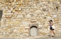 Tourist Woman Is Passing Front Of The Historical Cesme Castle