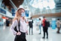 Tourist Woman With Protection Face Mask at The Airport Terminal in Coronavirus Covid-19 Pandemic, Defensive Measure for Travel
