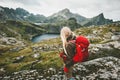 Tourist woman with red backpack hiking in mountains Royalty Free Stock Photo