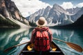 Tourist woman is sailing on a boat on a transparent lake among the mountains. Back view. Ai generated Royalty Free Stock Photo