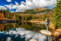 Tourist woman on the shore of mountain lake Rakytovske pliesko in High Tatras mountains in Slovakia Royalty Free Stock Photo