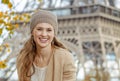 Tourist woman sitting on parapet on embankment near Eiffel tower Royalty Free Stock Photo