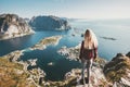 Tourist woman standing on cliff of Reinebringen mountain aerial view