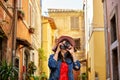 Tourist woman standing and focusing with camera