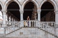 Udine - Tourist woman standing on stairs of Loggia del Lionello on main square Piazza della Liberta