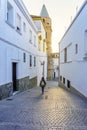 Tourist woman strolling through the narrow streets at sunset on a sunny day, Medina Sidonia, Cadiz.