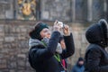 Tourist woman taking panoramic pictures in Edinburgh, Scotland