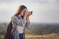 Tourist woman taking photo with her camera in nature Royalty Free Stock Photo