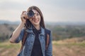 Tourist woman taking photo with her camera in nature Royalty Free Stock Photo